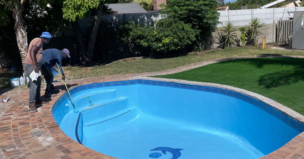 Swimming pool painting completed after fibreglass lining and tissue mosaic installation, showcasing a freshly renovated concrete pool in Cape Town by Pools Reno