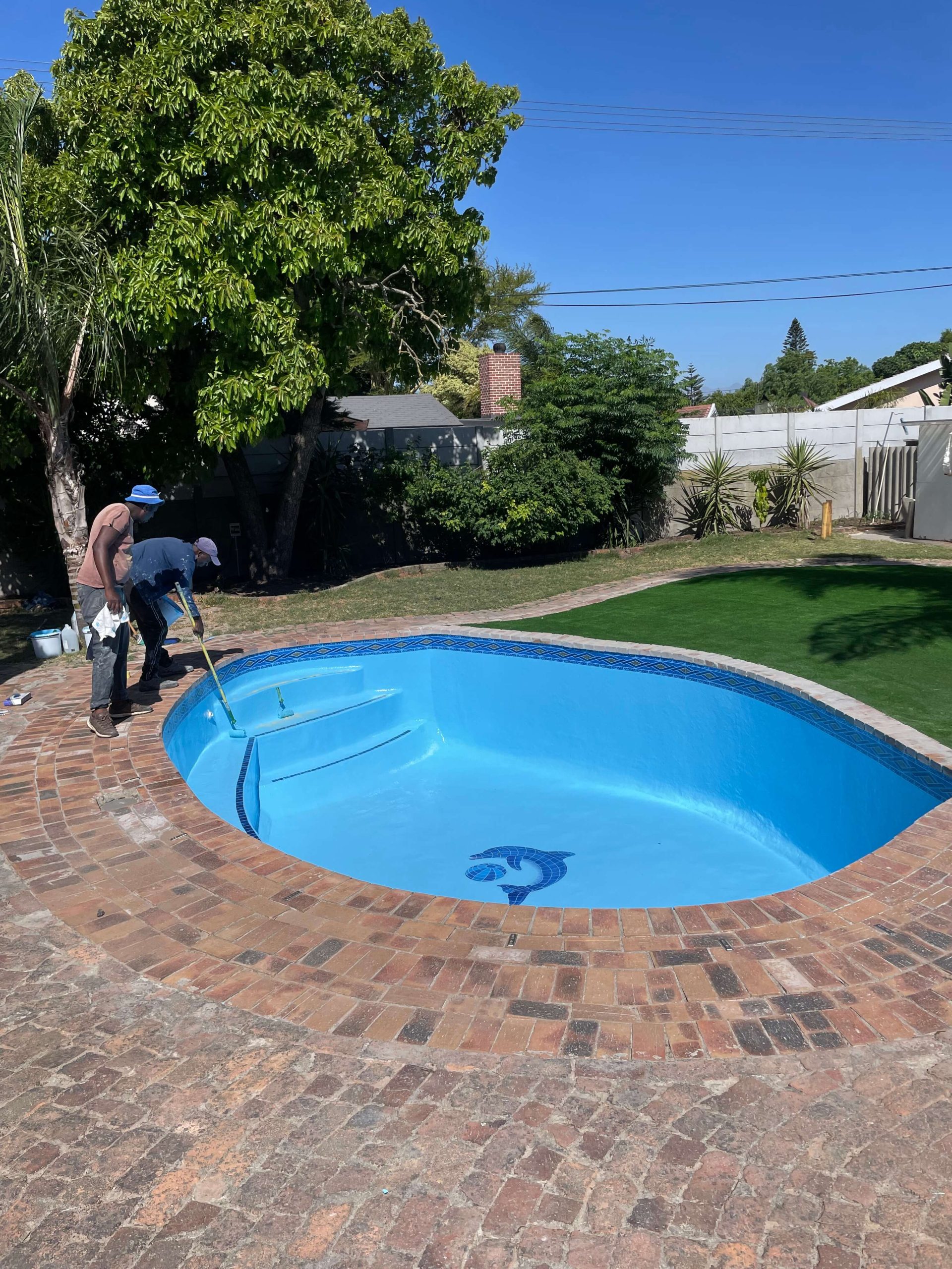Swimming pool painting completed after fibreglass lining and tissue mosaic installation, showcasing a freshly renovated concrete pool in Cape Town by Pools Reno