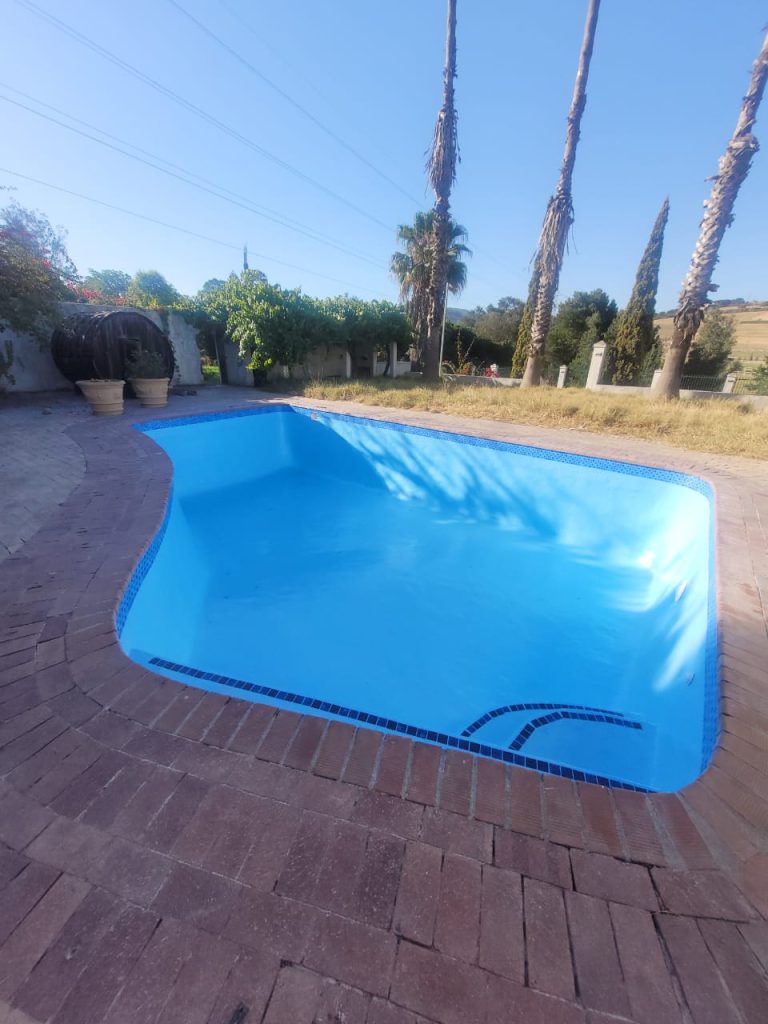 Smooth blue swimming pool after fibreglass lining, relining, and painting in Pringle Bay