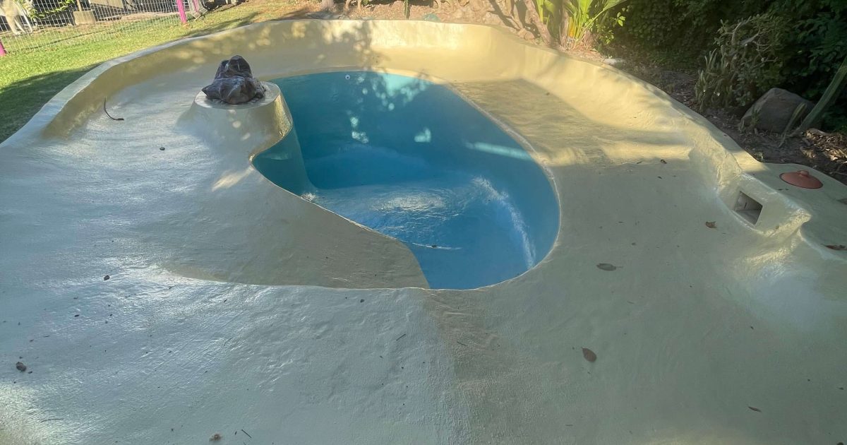 Fully renovated swimming pool in Stellenbosch with new fibreglass lining showing a smooth modern blue finish