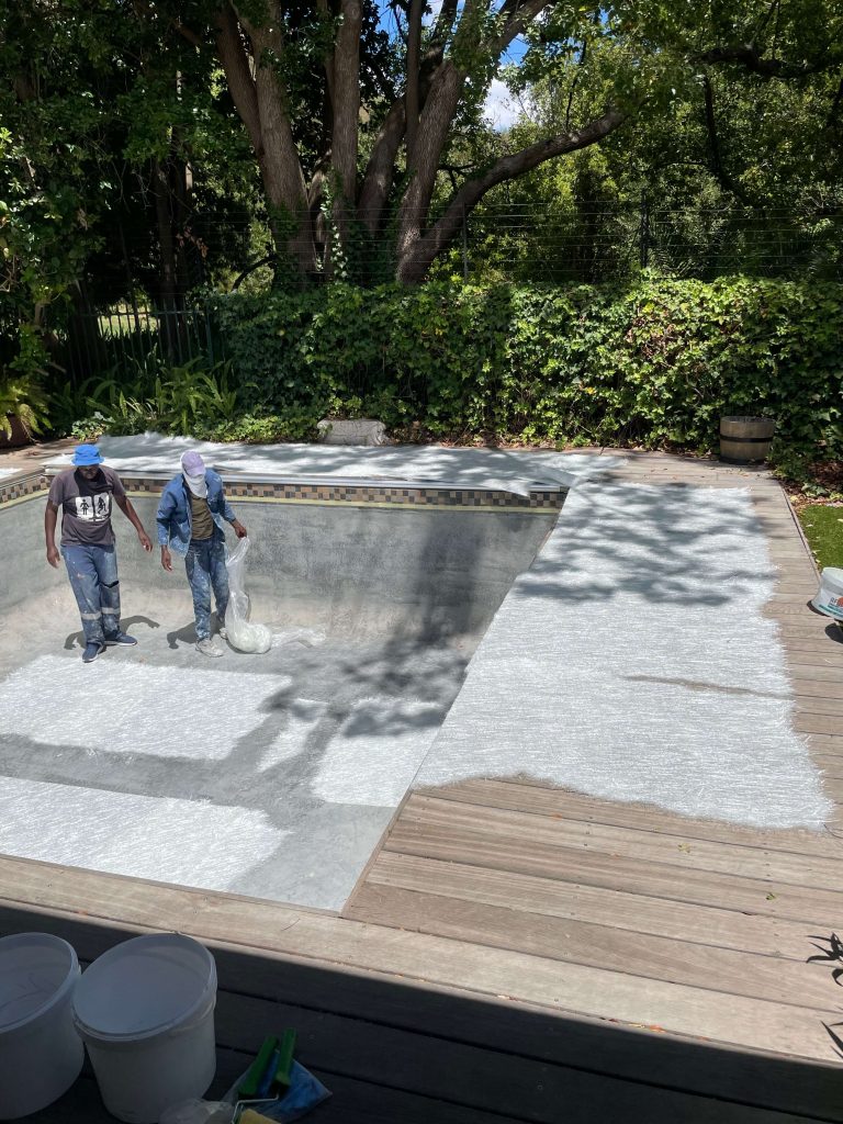 Repairing cracks in a damaged swimming pool in Tableview Cape Town before applying fibreglass lining to prevent leaks