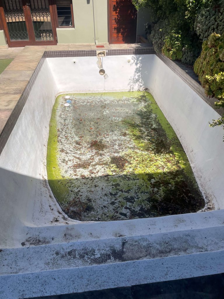 old swimming pool before fibreglass relining Durbanville cracked and worn surface