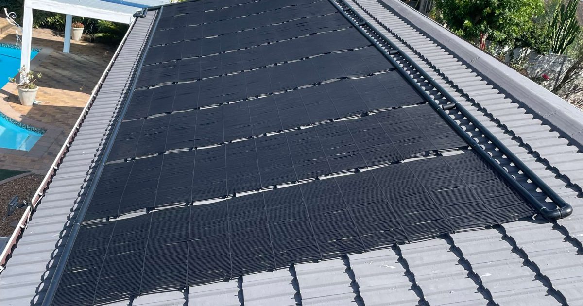 Swimming pool solar panel heating system installed in Durbanville Cape Town by Pools Reno for energy-efficient pool temperature control