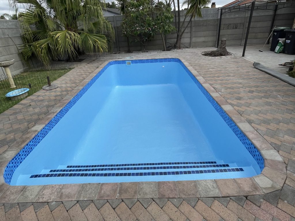 Before and after swimming pool renovation showing fibreglass lining upgrade in Cape Town South Africa