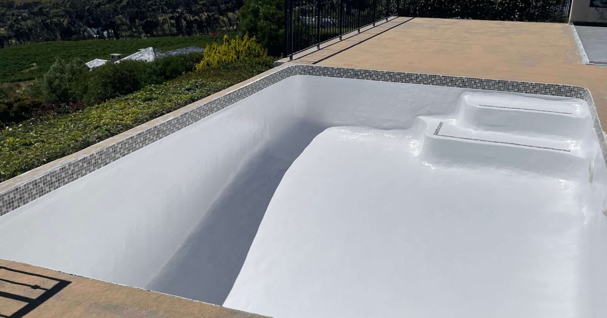 Newly fibreglass lined and painted swimming pool in Cape Town with smooth modern finish and clear water