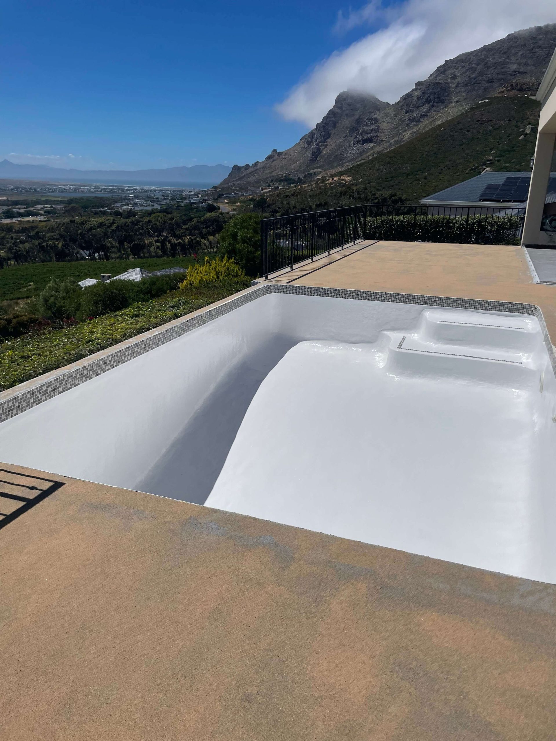Newly fibreglass lined and painted swimming pool in Cape Town with smooth modern finish and clear water