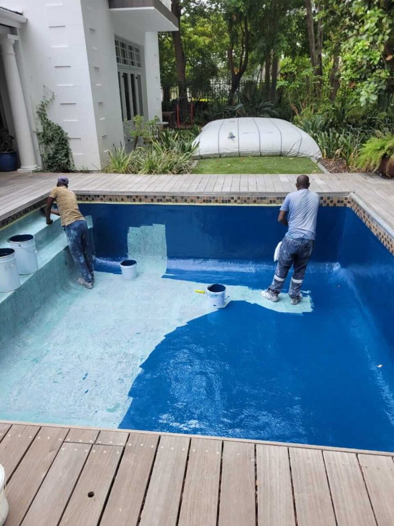 Applying gelcoat finish to a fibreglass swimming pool in Tableview Cape Town creating a smooth waterproof and durable surface during relining process