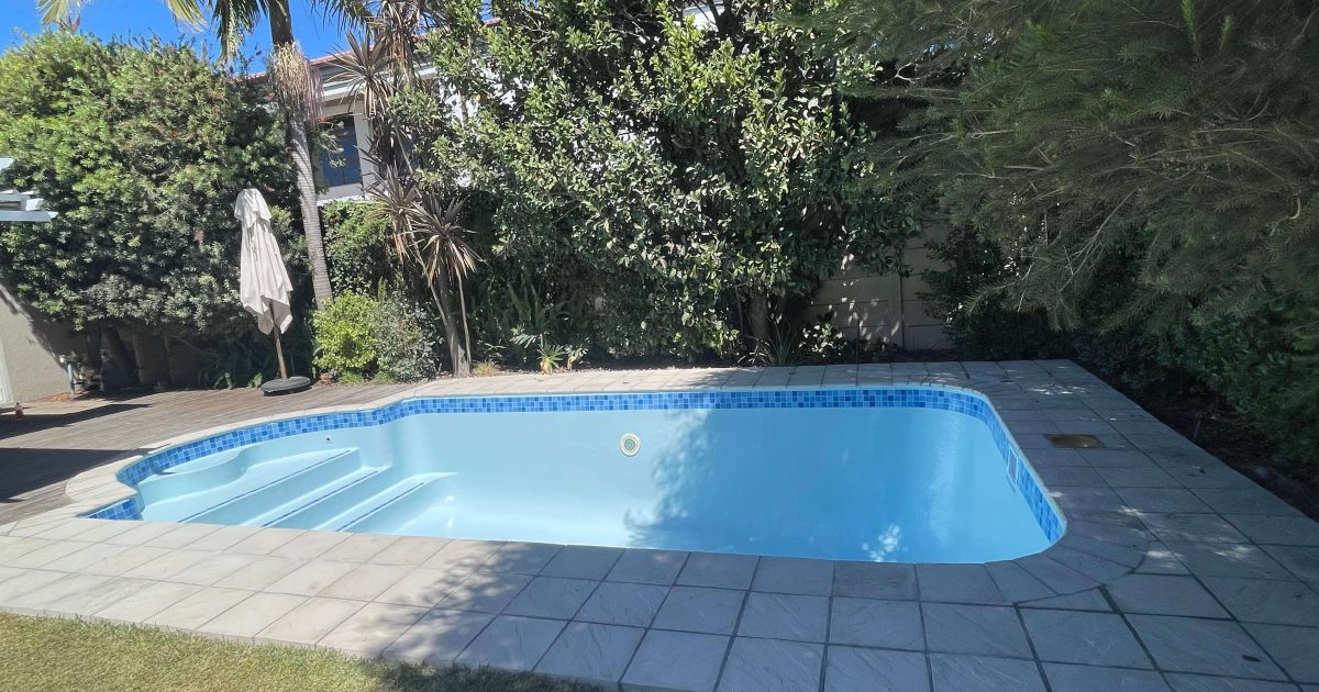 Well fibreglass relined swimming pool in Kuils River Cape Town showing a smooth durable finish after professional pool resurfacing and renovation