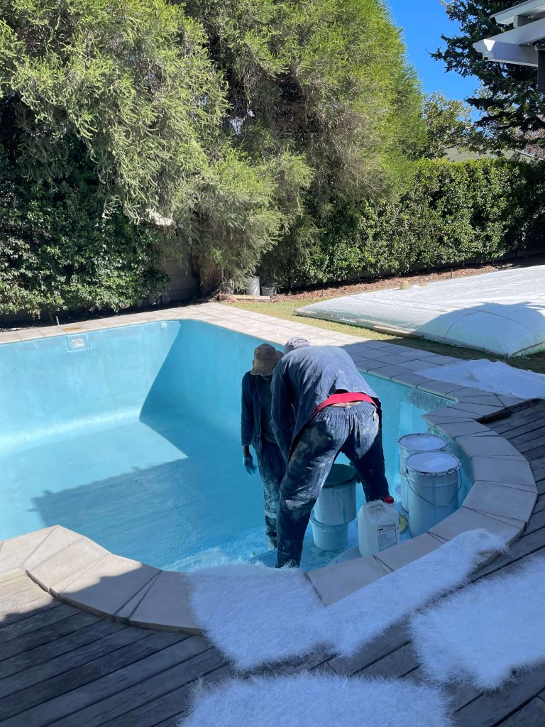 Fibreglass lining process of a swimming pool in Kuils River Cape Town showing installation and resurfacing before final gelcoat finish
