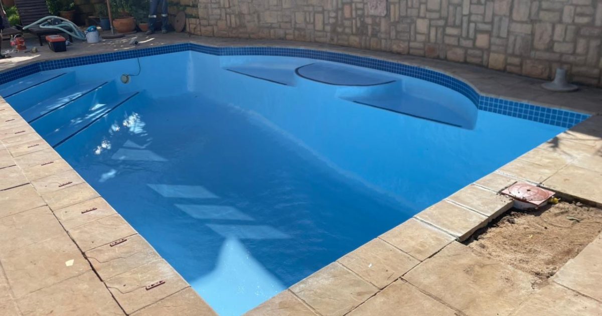 Finished fibreglass relined swimming pool in Strand Cape Town with smooth modern finish after pool renovation near the coast