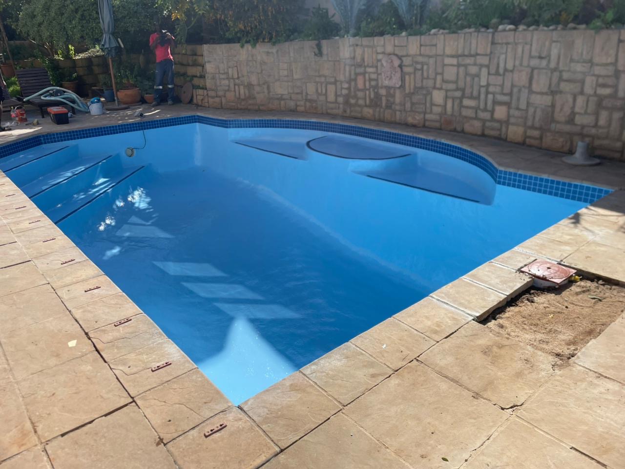 Finished fibreglass relined swimming pool in Strand Cape Town with smooth modern finish after pool renovation near the coast