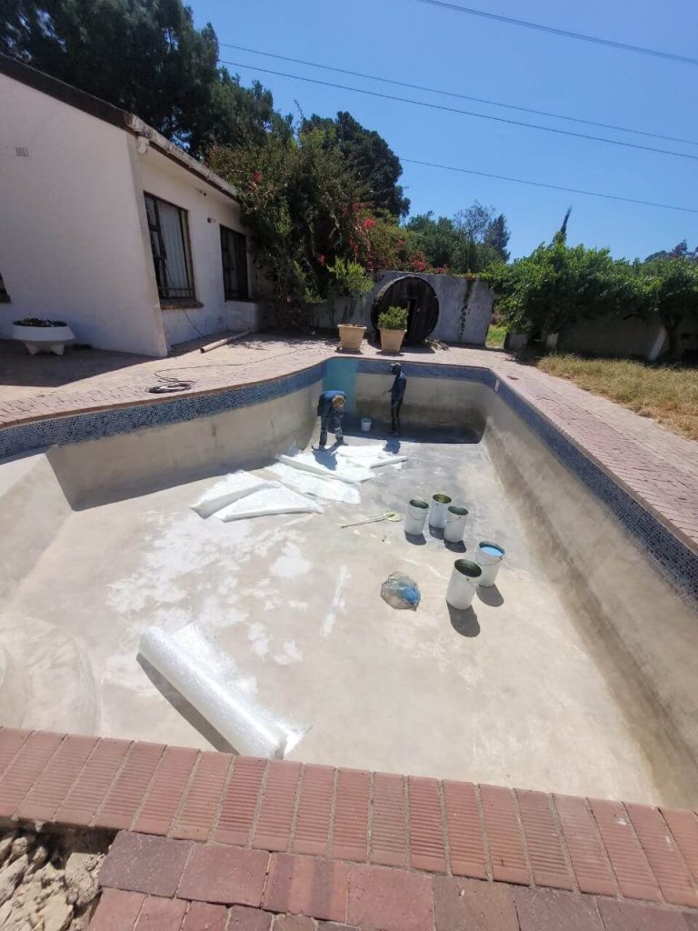 Start of fibreglass pool relining in Milnerton Cape Town showing surface preparation and cleaning before installation