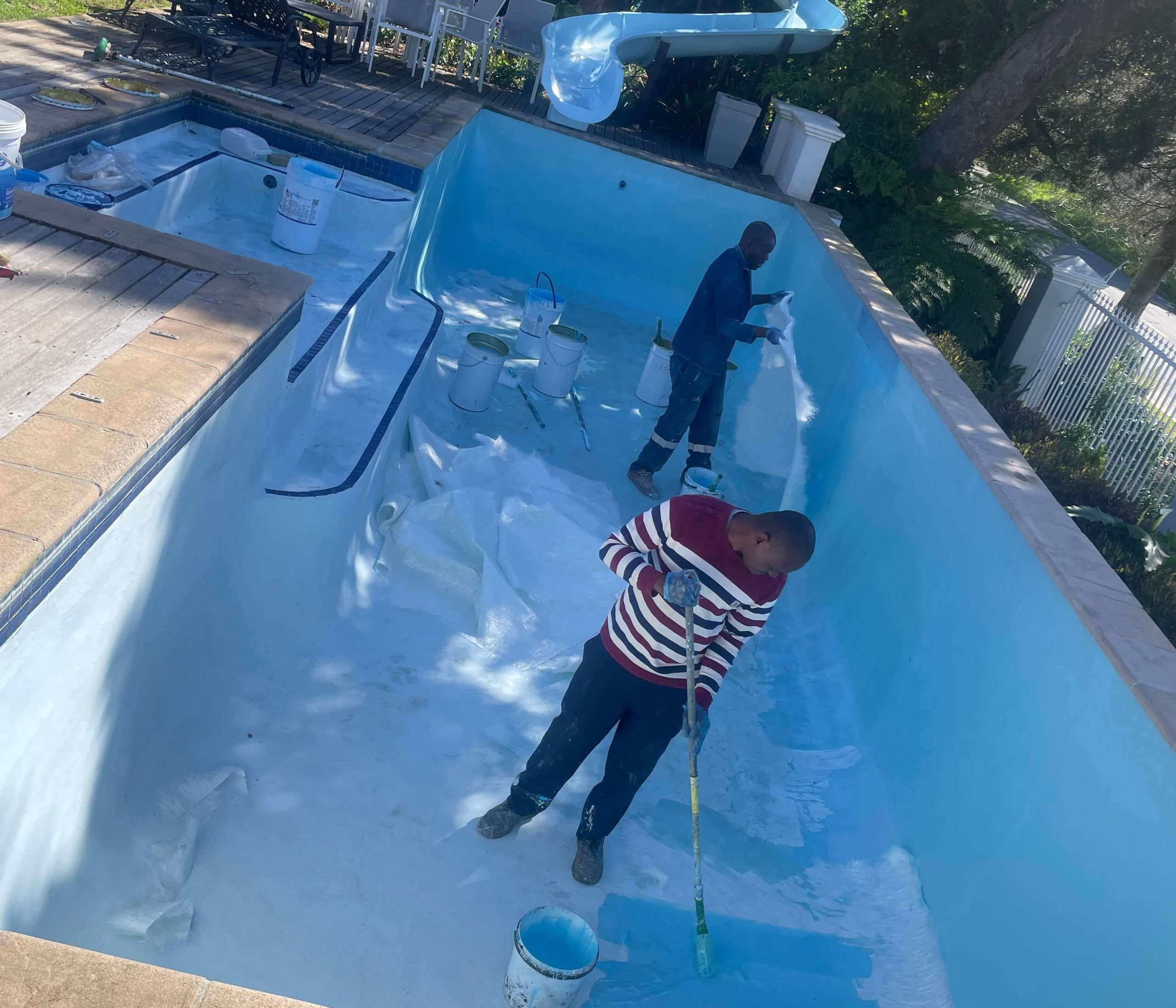 Technicians installing fibreglass lining during swimming pool renovation in Cape Town