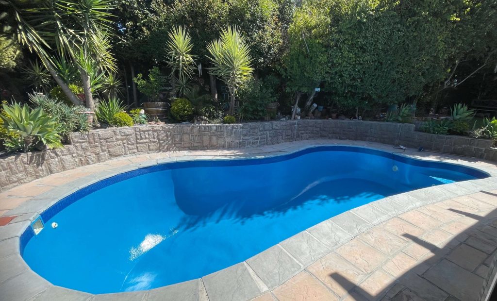 Newly renovated fibreglass swimming pool with smooth blue finish in Cape Town Western Cape