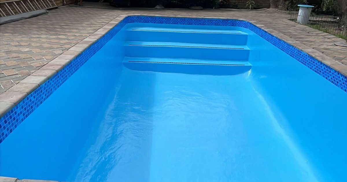 Modern renovated swimming pool in Langebaan with blue water, new paving and upgraded coastal pool finish
