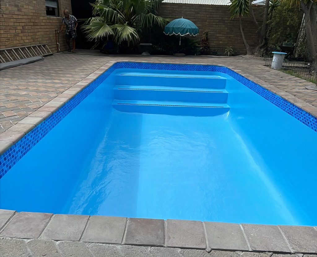 Newly fibreglass lined swimming pool with modern blue finish in Western Cape