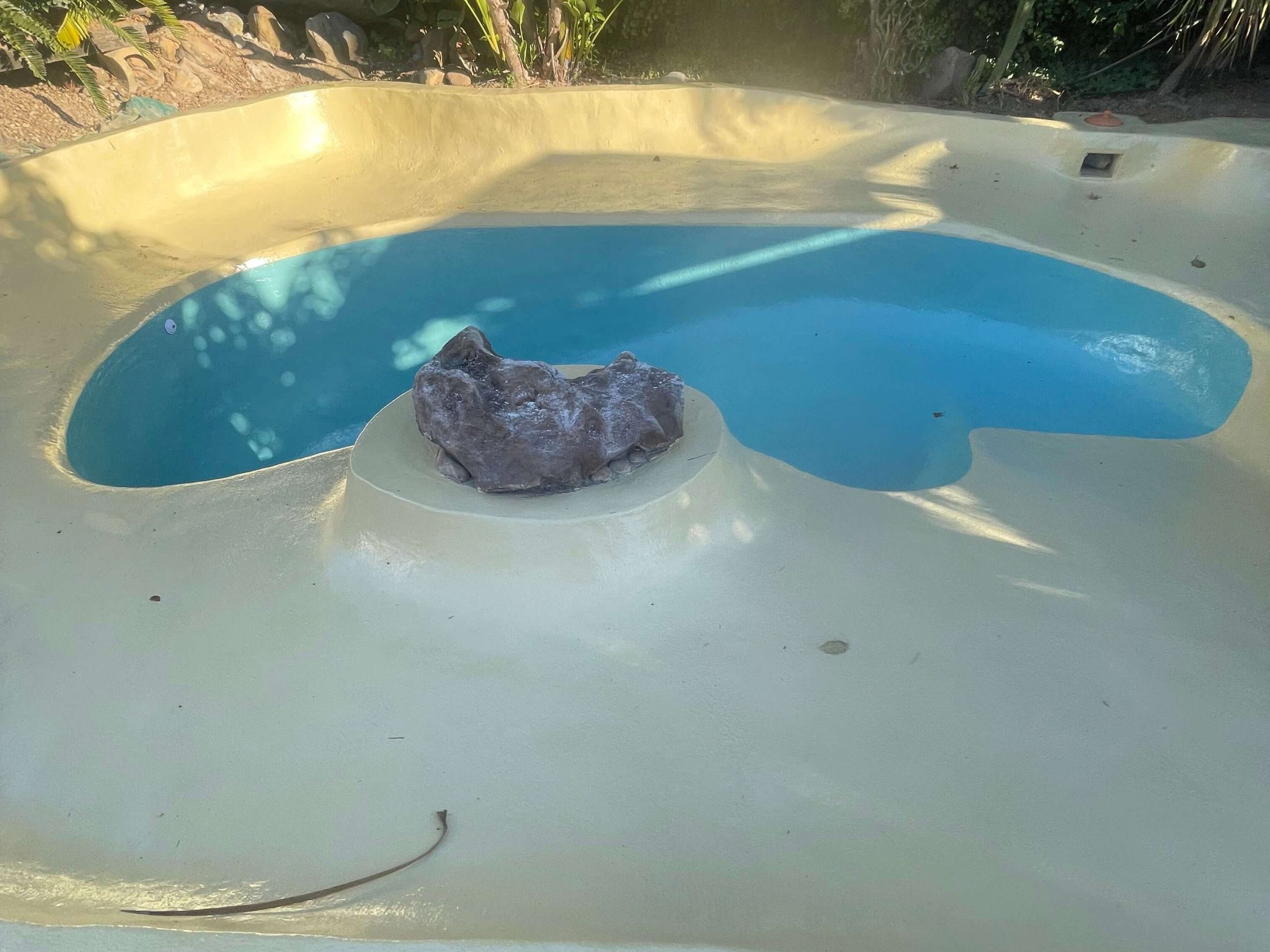 Newly fibreglass lined and painted sand colour ivory beach entry swimming pool in Cape Town with smooth durable finish after pool resurfacing