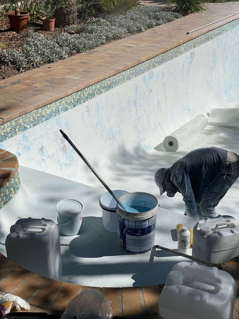 Fibreglass lining process of a swimming pool in Goodwood Cape Town showing installation and resurfacing before gelcoat finish