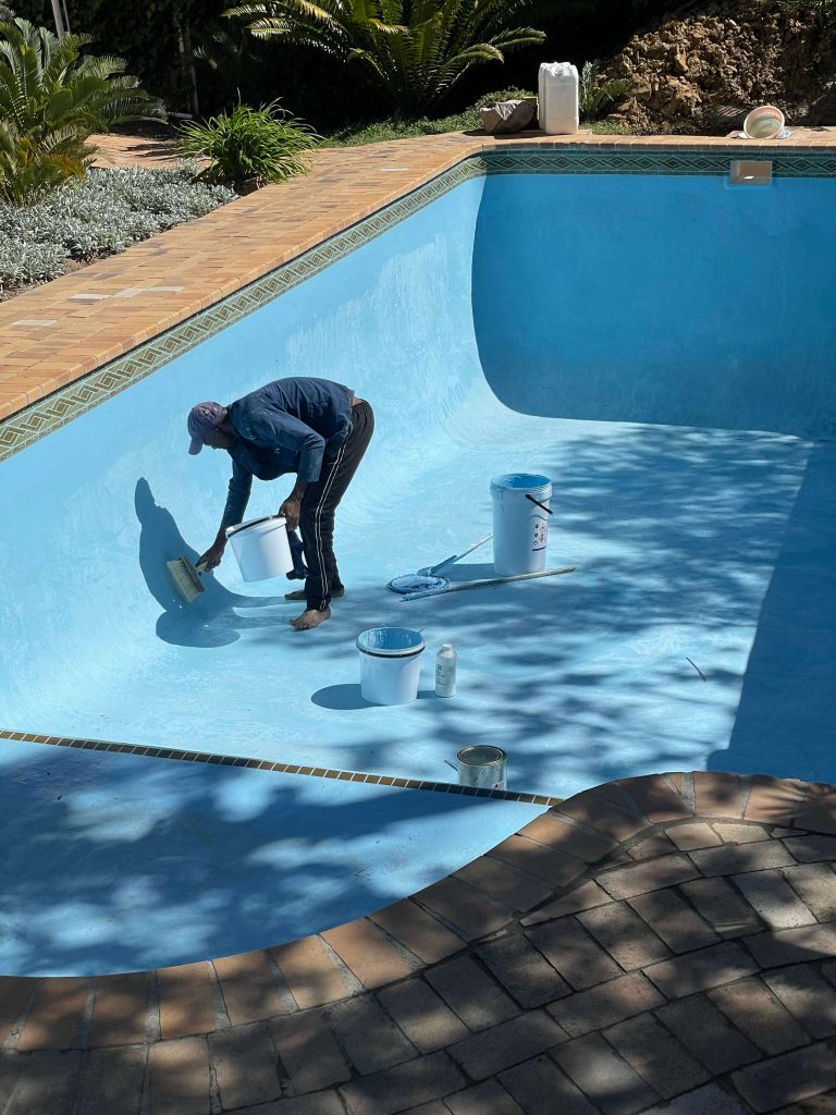Applying gelcoat finish to a fibreglass swimming pool in Goodwood Cape Town creating a smooth waterproof and durable surface
