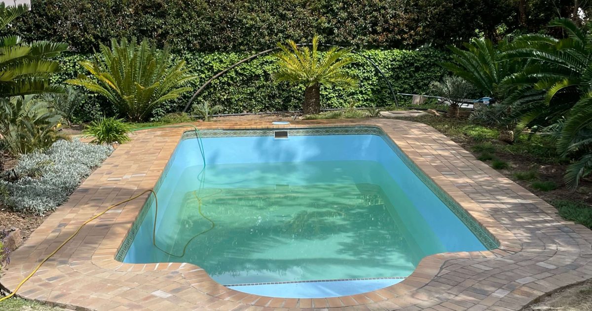 Newly fibreglass relined pool in Goodwood Cape Town with a shiny smooth finish ready to be filled with water after renovation