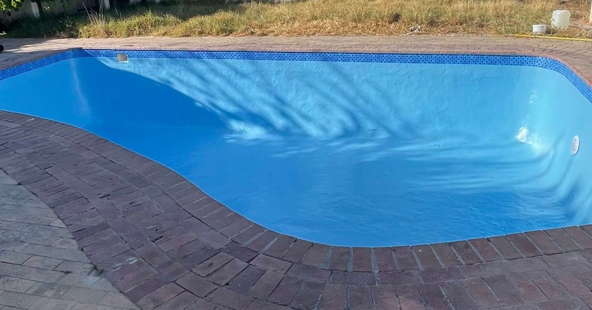 Old marbelite swimming pool upgraded with fibreglass lining showing smooth blue modern finish in Cape Town