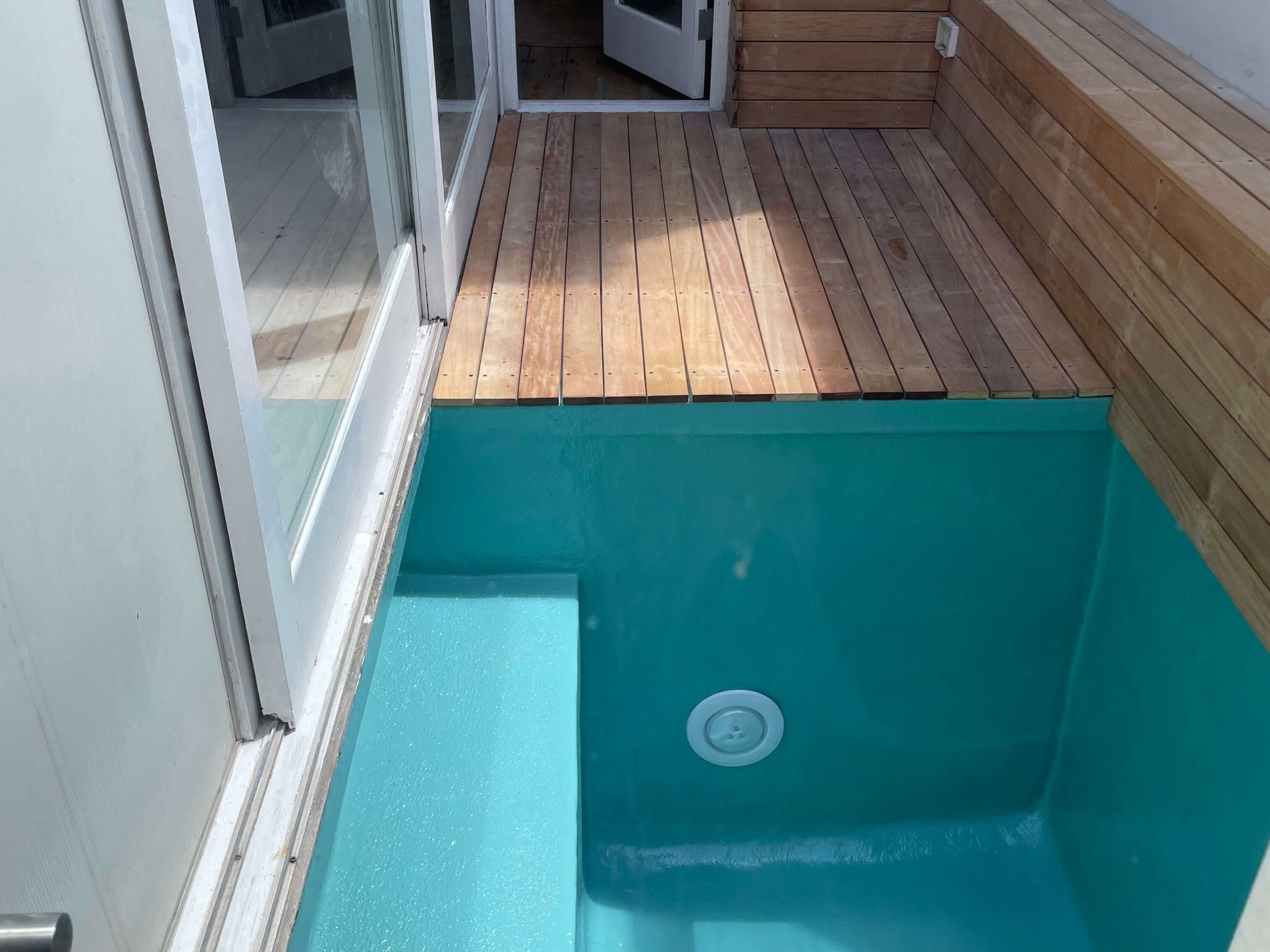Newly fibreglass lined and painted turquoise swimming pool in Cape Town with a smooth glossy finish after professional pool resurfacing