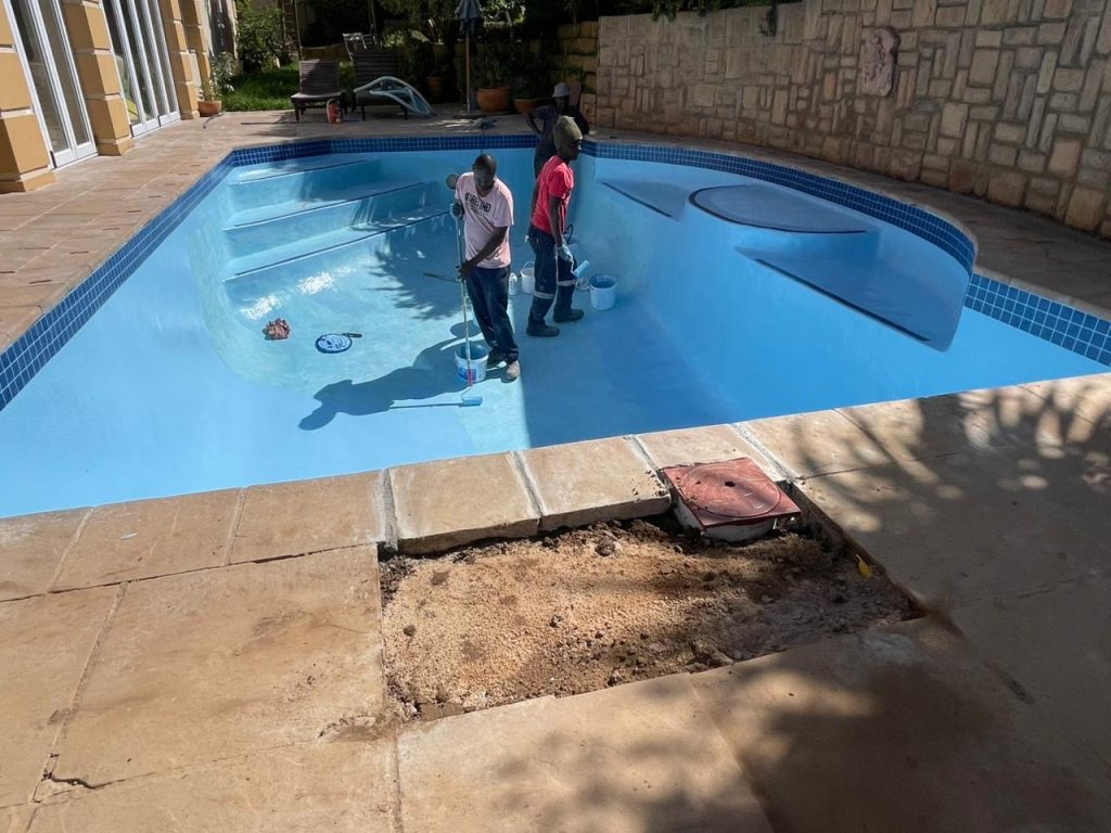 Applying gelcoat finish to a fibreglass swimming pool in Strand Cape Town creating a smooth durable waterproof surface for coastal conditions