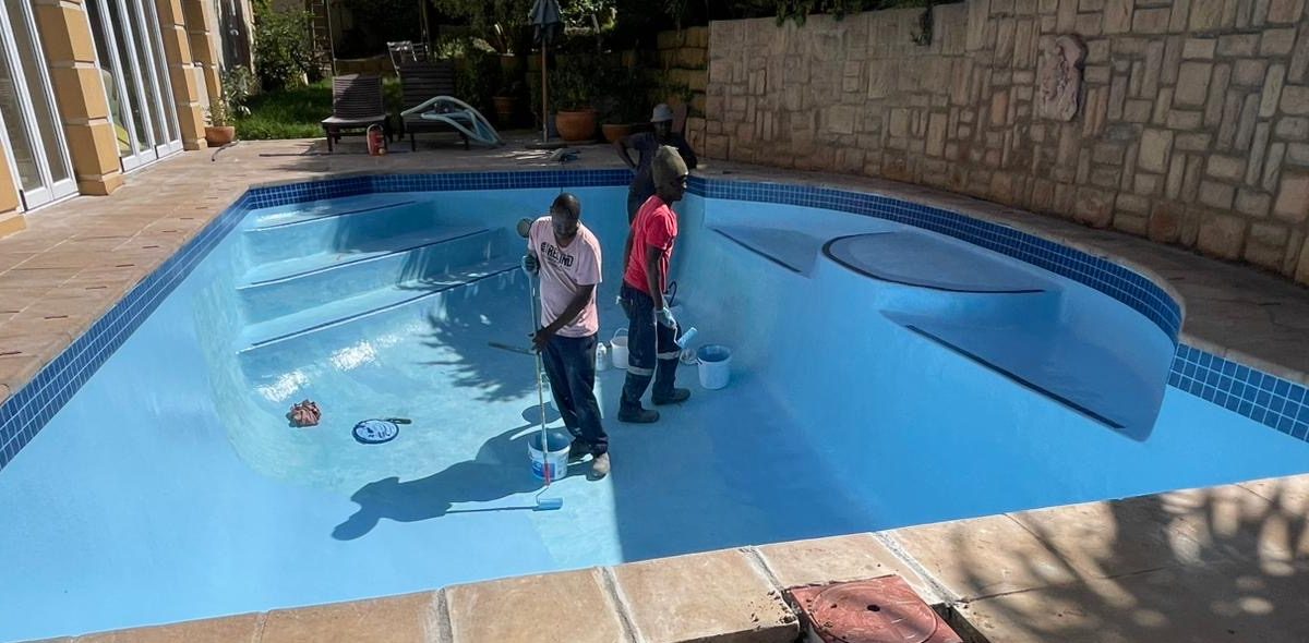Applying gelcoat finish to a fibreglass swimming pool in Langebaan creating a smooth durable waterproof surface for coastal conditions