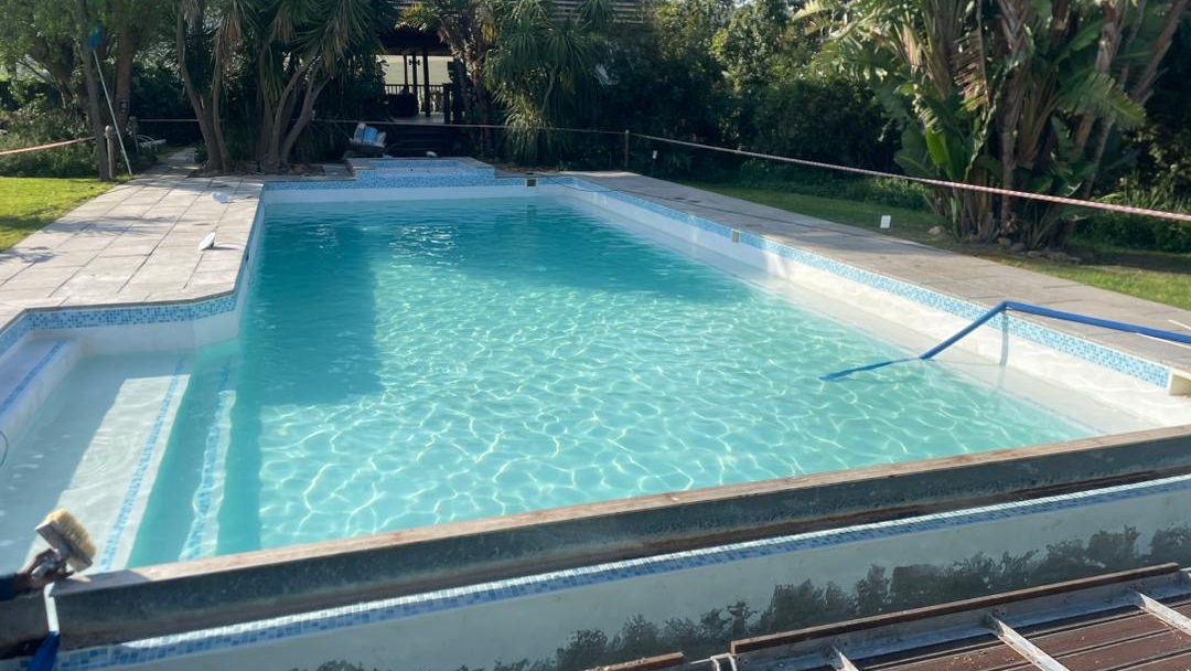 Marbelite swimming pool after resurfacing with black algae removed showing clean smooth blue surface in Cape Town