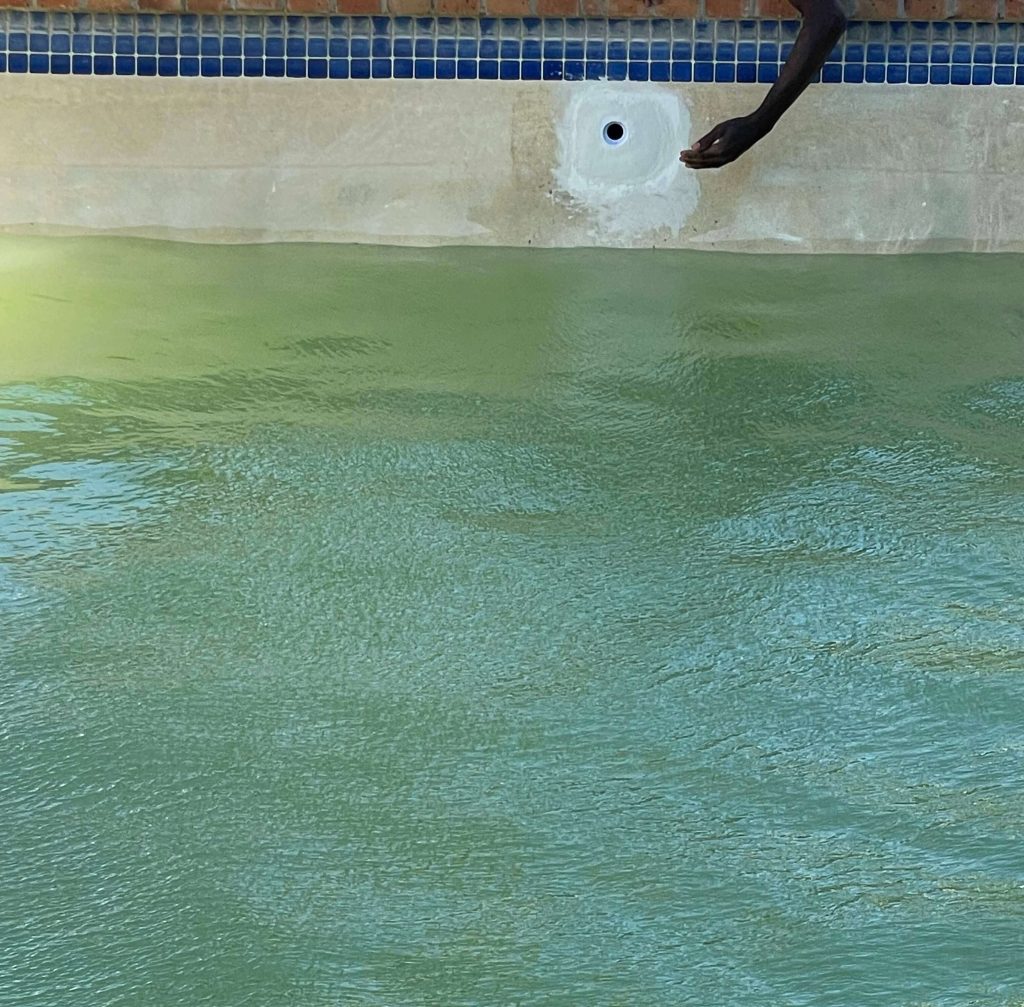 Our team repairing a leaking return fitting on a marbelite pool at the waterline