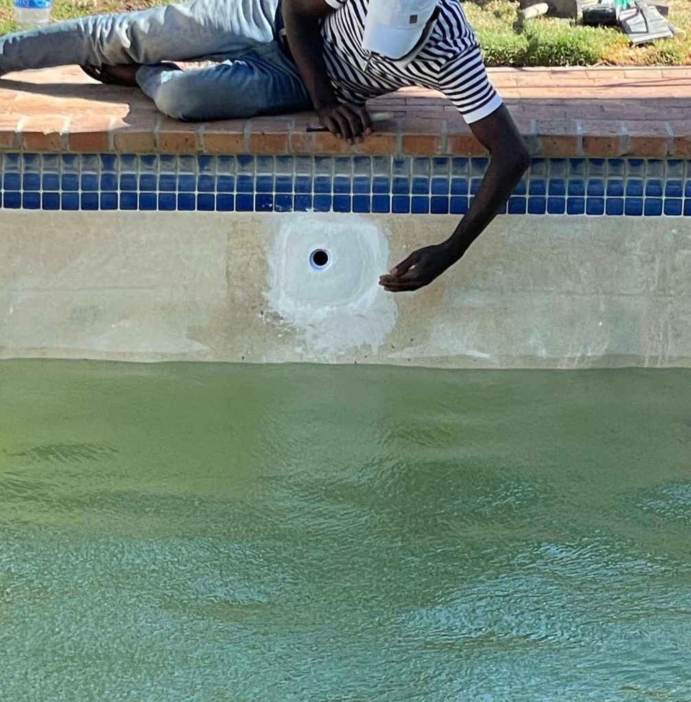 Pool technician repairing leaking marbelite pool at aim flow area in Cape Town fixing water loss and structural damage