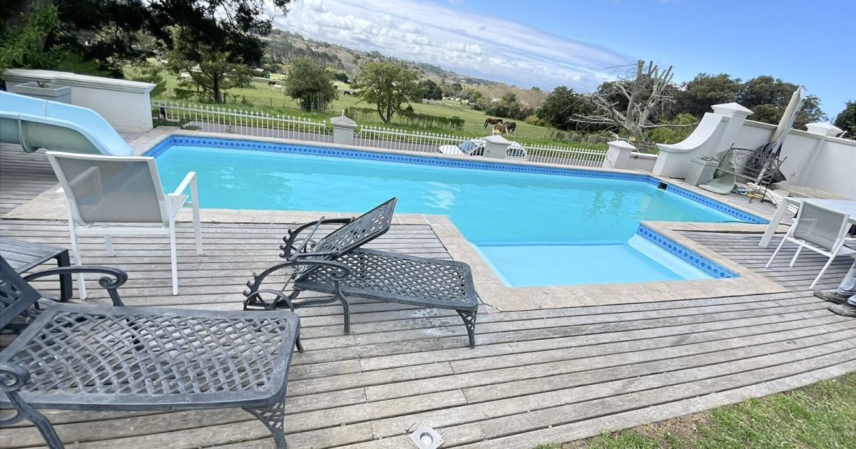 Modern renovated swimming pool in Melkbostrand with fresh blue water, new paving and upgraded coastal pool finish