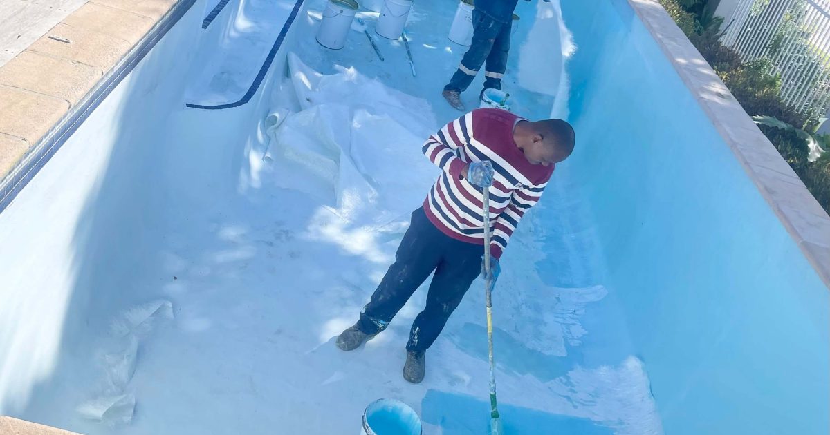 Pool technicians installing fibreglass lining inside a swimming pool during a professional pool renovation project in Cape Town, Western Cape South Africa.