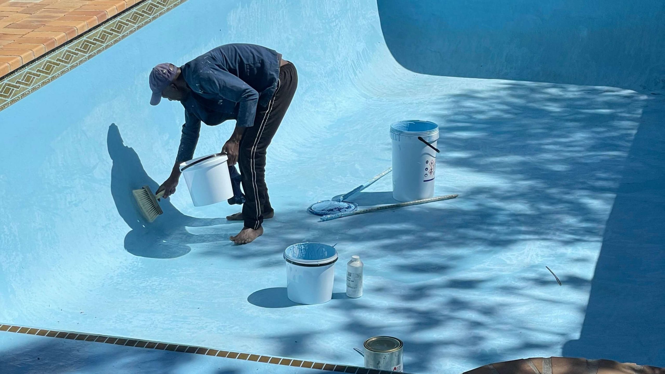 Close-up of fibreglass pool gel coat application in Durbanville during final stage of pool relining, creating smooth durable waterproof swimming pool surface finish