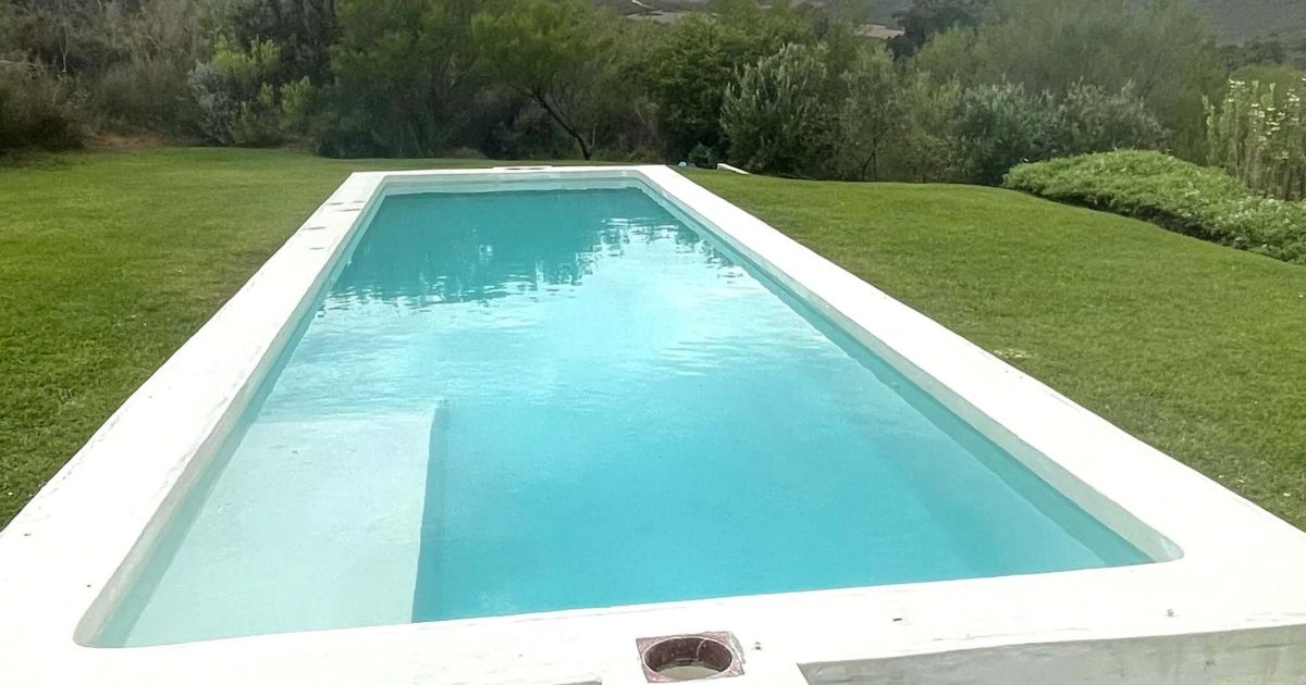 Freshly resurfaced white marbelite swimming pool in Melkbostrand filled with clear water showcasing smooth modern renovation finish
