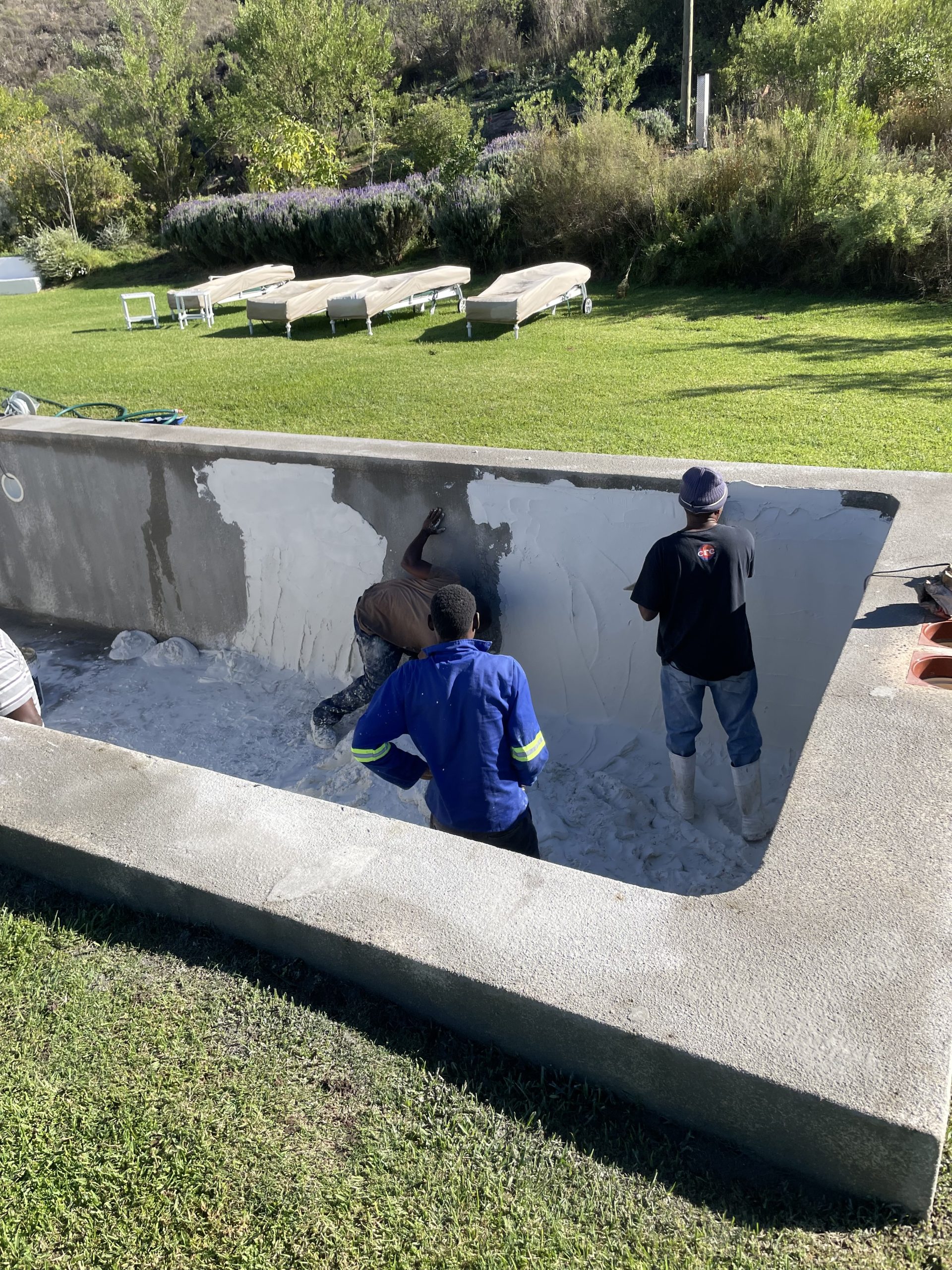 Professional marbelite resurfacing in Langebaan swimming pool during renovation process