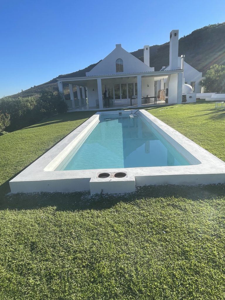 Before and after swimming pool renovation in Langebaan showing cracked old surface transformed into modern blue pool