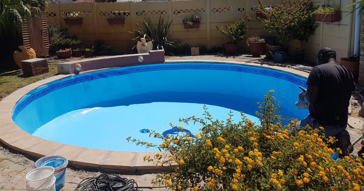 Pools Reno technician busy renovating a swimming pool in Riebeek-Kasteel during fibreglass lining, surface preparation and pool restoration work in the Western Cape