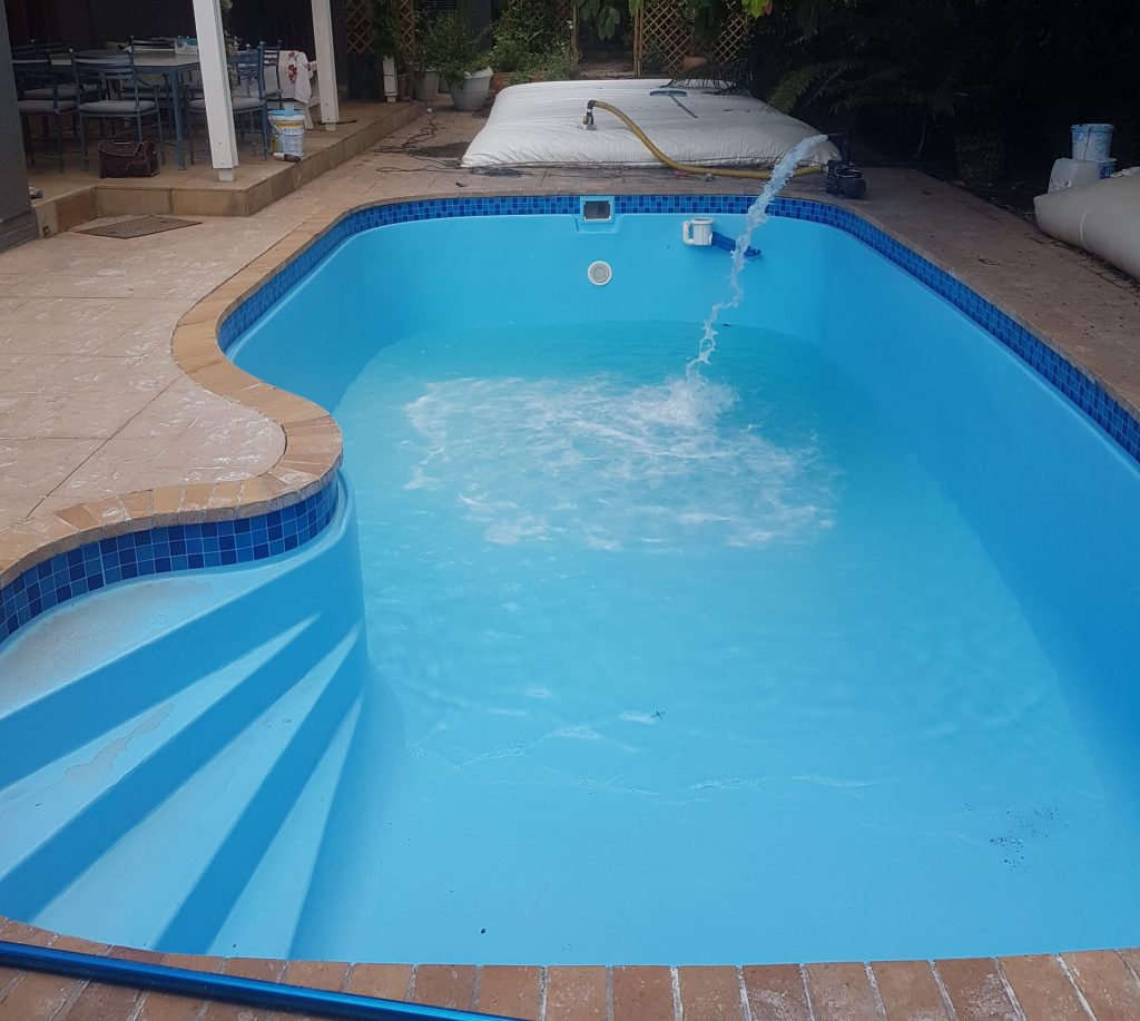Fibreglass lined and freshly painted blue swimming pool in Riebeek-Kasteel with smooth modern finish, clear water and restored pool surface by Pools Reno Western Cape