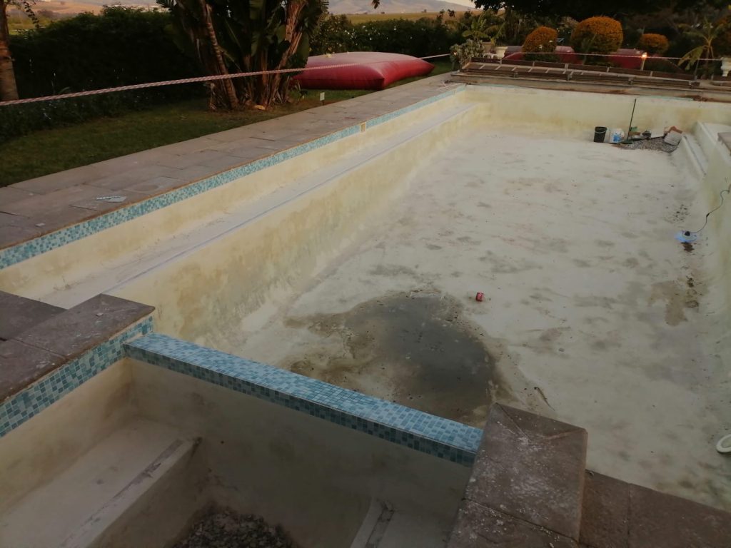 Worn marbelite swimming pool in Langebaan with rough faded surface requiring resurfacing and pool renovation