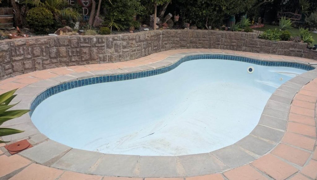Swimming pool renovation in Melkbosstrand showing before and after fibreglass lining and painting with modern smooth blue pool finish