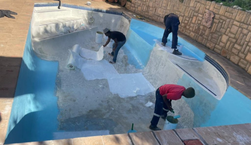 “Old cracked marbelite swimming pool in Philadelphia Western Cape showing surface erosion and algae staining before renovation”