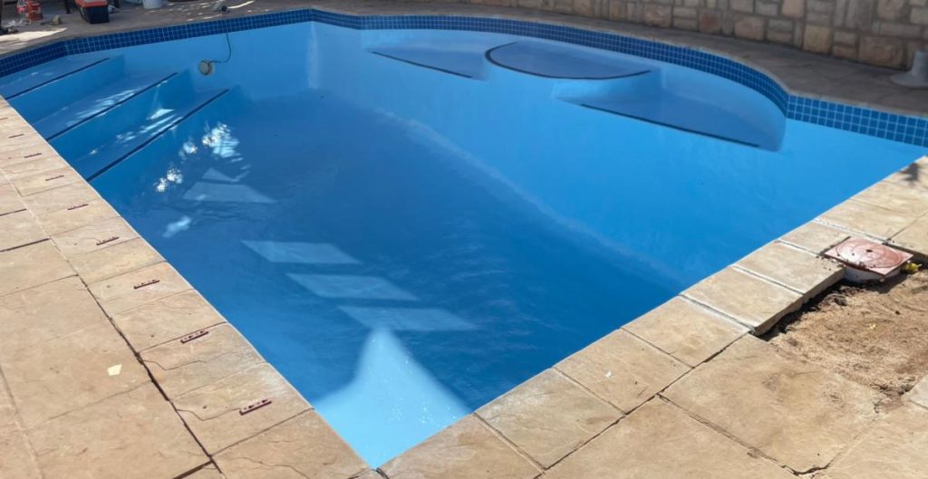“Fully restored smooth fibreglass swimming pool in Philadelphia Western Cape with bright blue water and seamless finish”