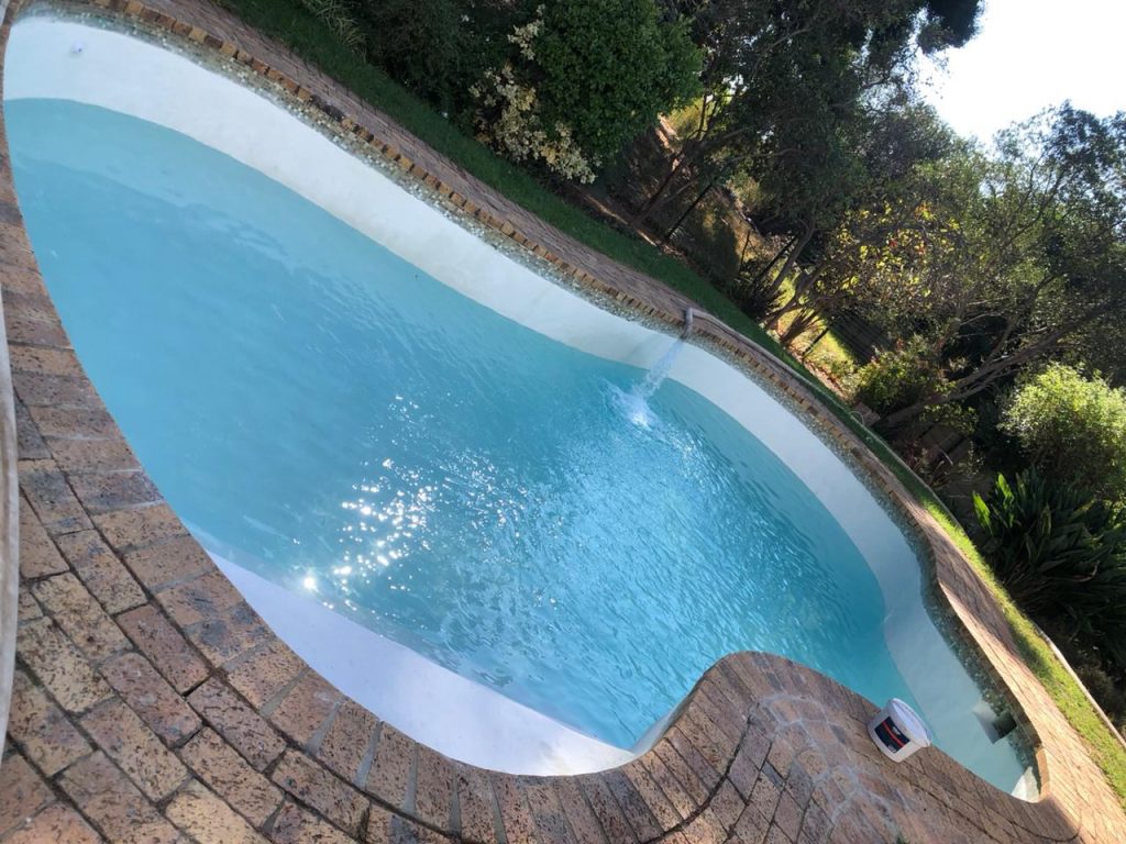 “Luxury renovated swimming pool in Philadelphia Western Cape illuminated at sunset after full renovation”