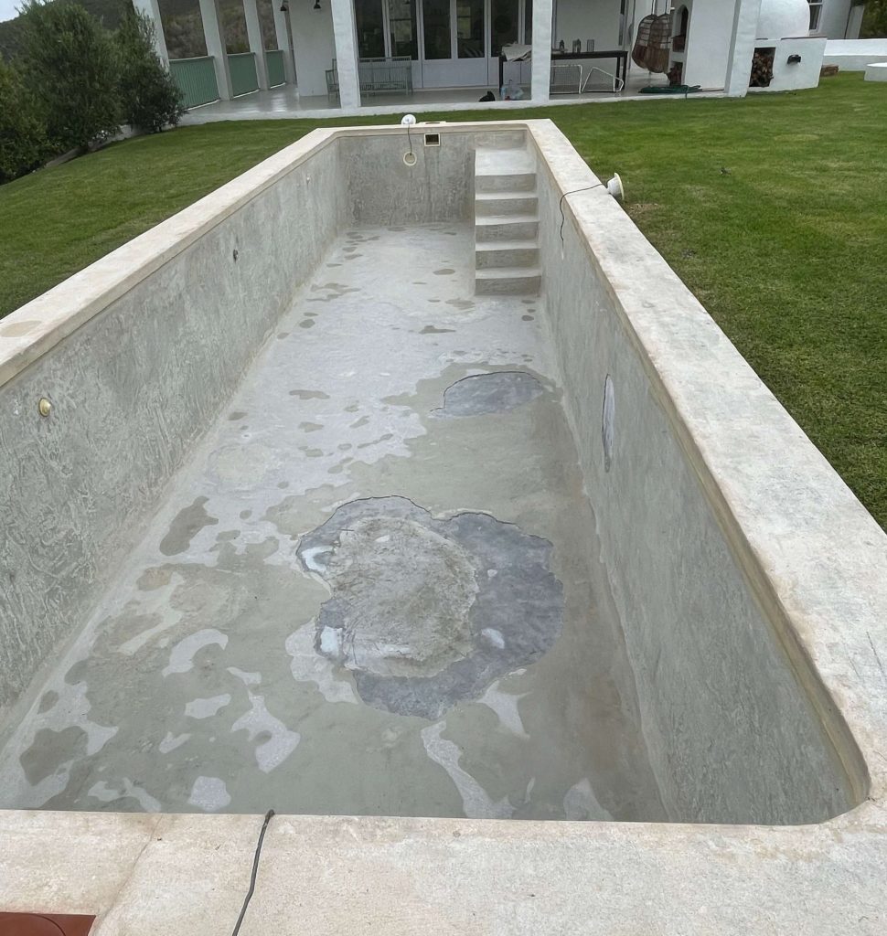 Old cracked marbelite gunite swimming pool before fibreglass relining in Yzerfontein