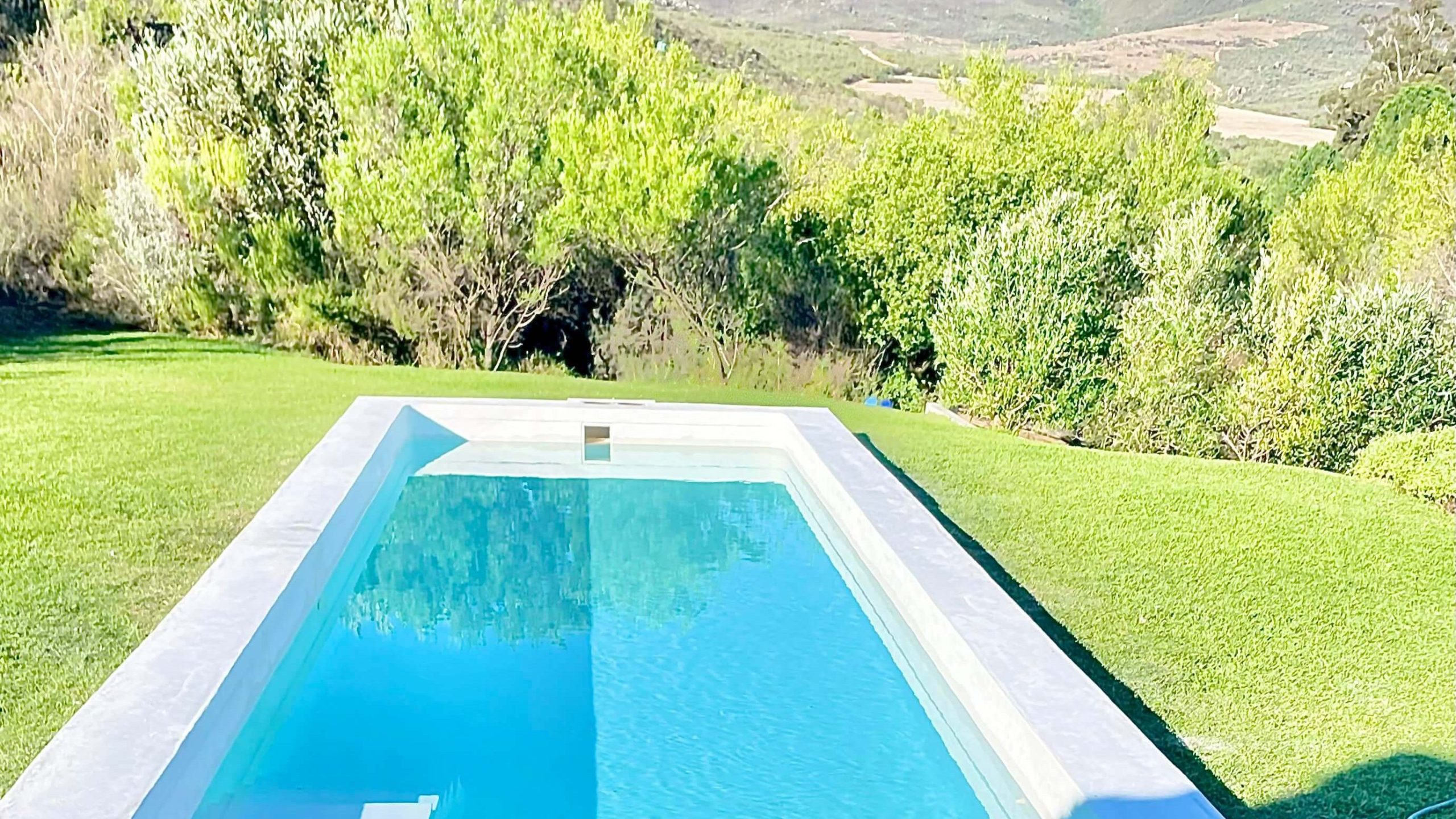 Modern fibreglass lined swimming pool after renovation in Grabouw