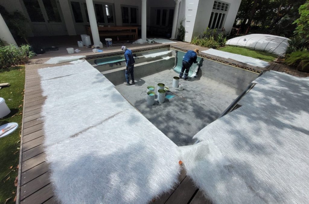 Fibreglass lining installation inside swimming pool during pool renovation in Melkbostrand