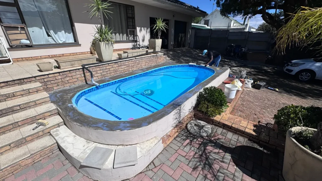 Raised pool with a fresh mortar bed along the top of the wall ready for copings