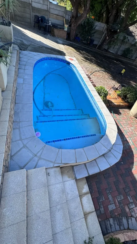 Pool with new bullnose copings around the curved end and the steps