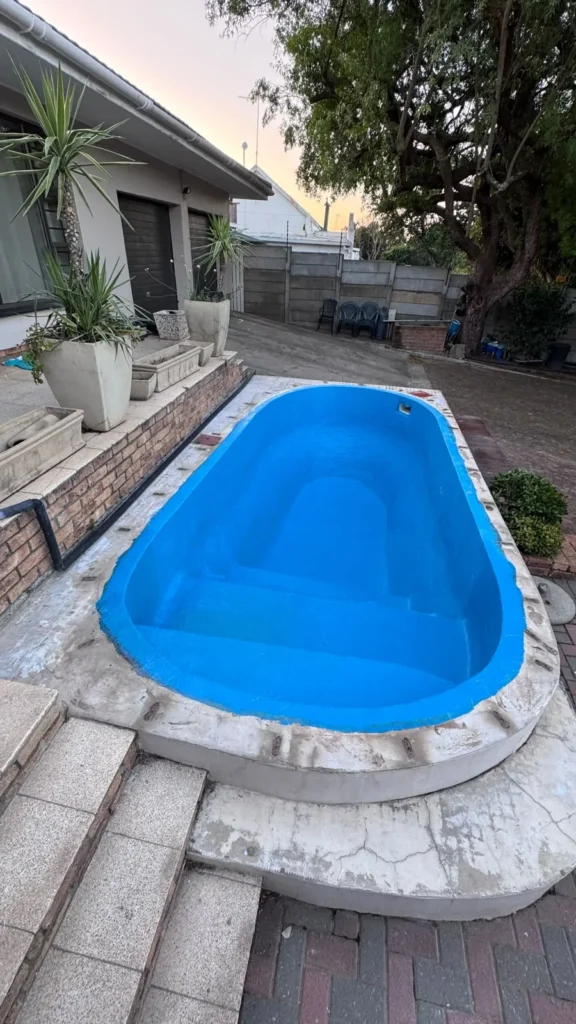 Oval pool fully laminated in new blue fibreglass before tiling and the final coat